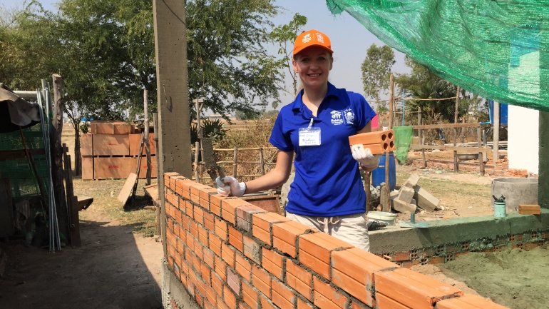 Habitat volunteer laying bricks