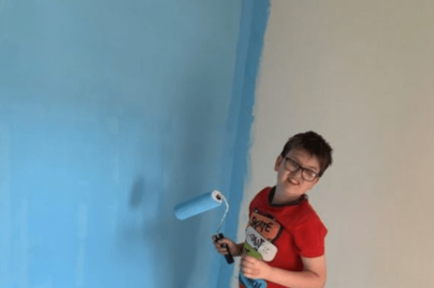 Boy painting wall