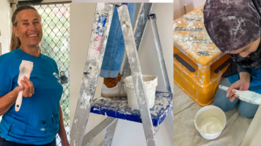 Three photographs. The first photo shows a lady in a blue Habitat t-shirt holding a paint brush and smiling. The second photo is of someone's shoes standing on a ladder. The third image is of a girl in a headscarf sitting on the floor and painting a wall.