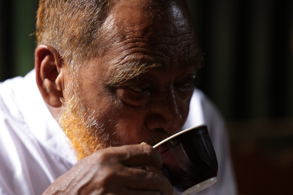 A man in Dhaka, Bangladesh drinks from a tea cup